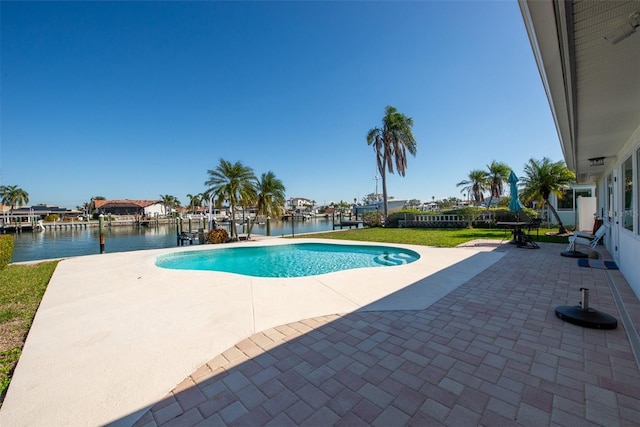 view of pool featuring a patio and a water view