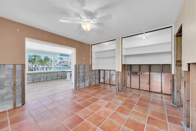 unfurnished living room with ceiling fan and light tile patterned floors