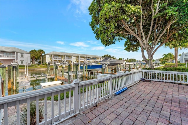 view of patio featuring a dock and a water view