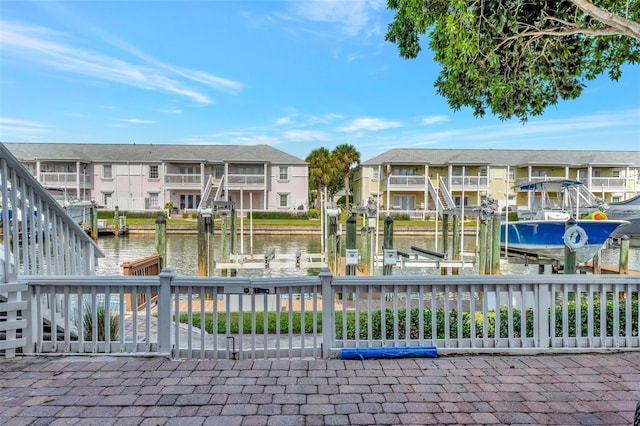 view of home's community featuring a water view and a boat dock