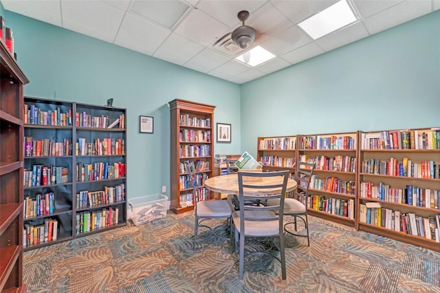 office space featuring ceiling fan and a drop ceiling