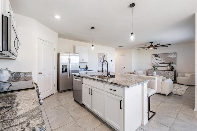 kitchen with white cabinets, sink, and appliances with stainless steel finishes