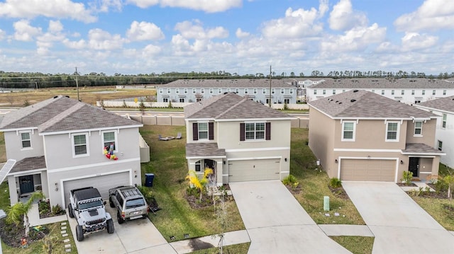 view of front of house featuring a garage and a front lawn