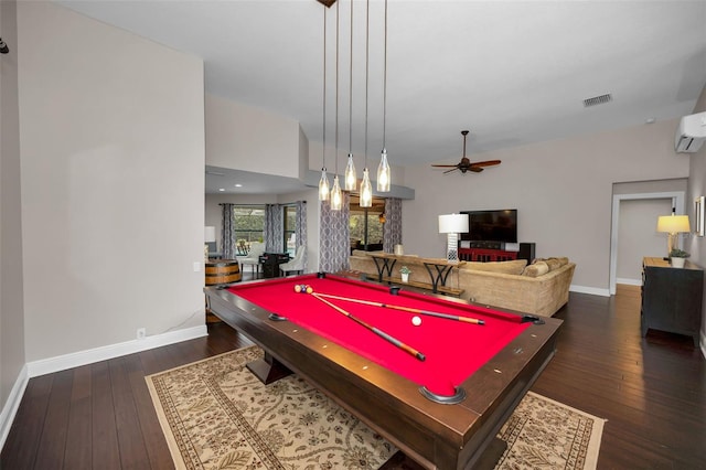 rec room featuring ceiling fan, a wall mounted AC, and dark hardwood / wood-style flooring