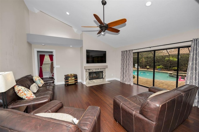 living room with ceiling fan, a fireplace, lofted ceiling, and dark hardwood / wood-style flooring