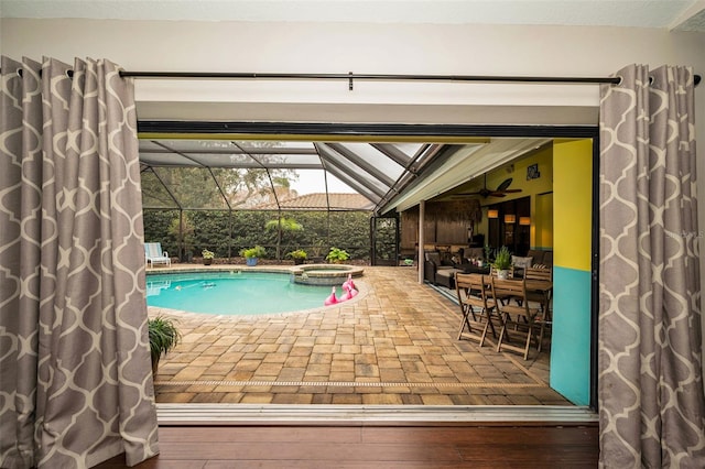 view of swimming pool featuring an in ground hot tub, glass enclosure, and a patio area