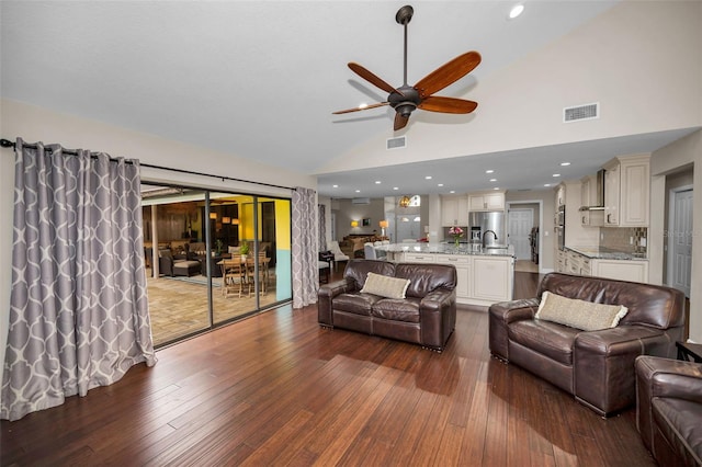 living room with ceiling fan, sink, dark hardwood / wood-style flooring, and high vaulted ceiling