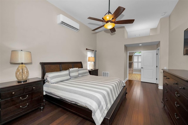 bedroom with dark wood-type flooring, ceiling fan, and an AC wall unit