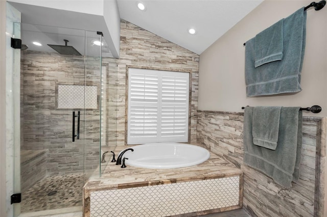 bathroom featuring vaulted ceiling and independent shower and bath