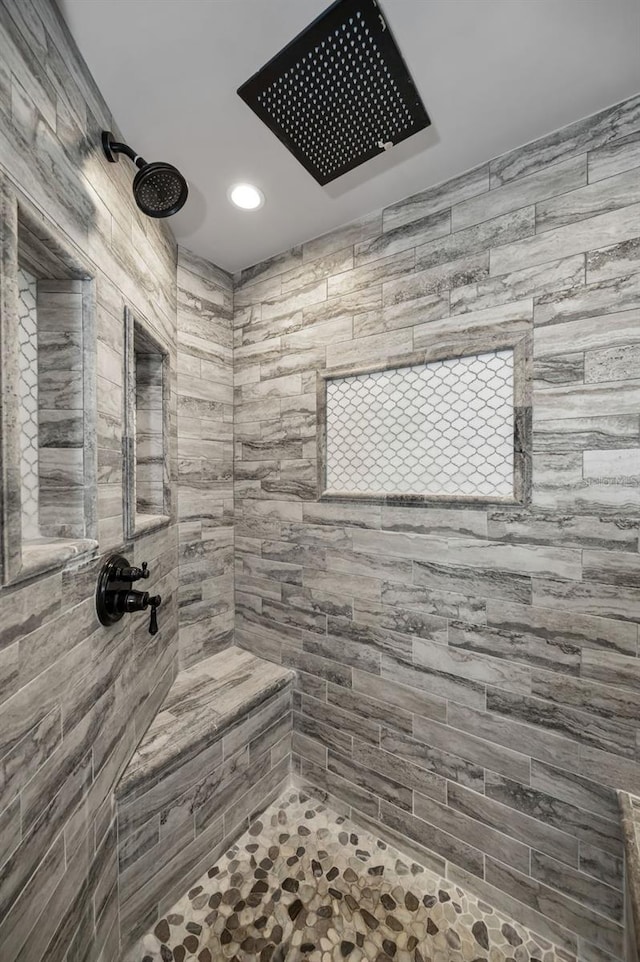 bathroom with a tile shower