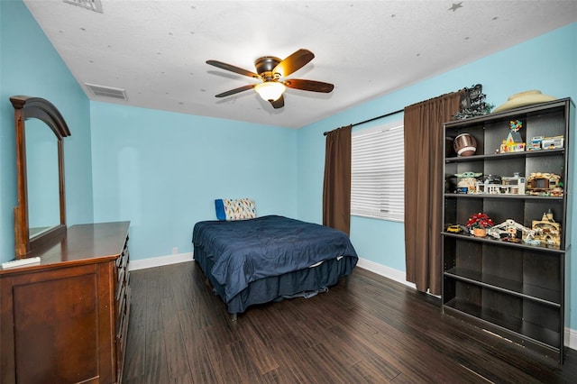 bedroom with dark wood-type flooring and ceiling fan