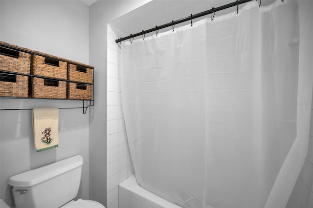 bathroom with toilet and shower / bath combo with shower curtain