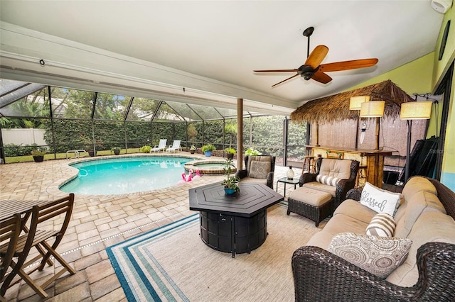 view of swimming pool with a patio, an outdoor hangout area, ceiling fan, and glass enclosure