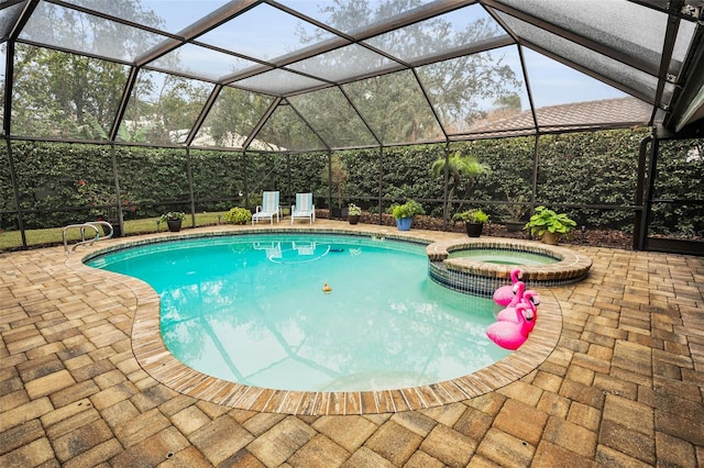 view of swimming pool with an in ground hot tub, a lanai, and a patio