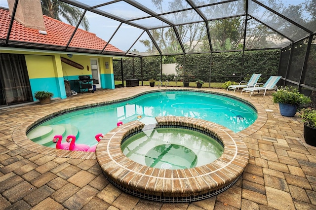 view of swimming pool featuring a grill, a lanai, a patio, and an in ground hot tub