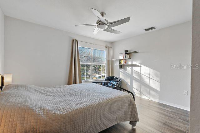 bedroom featuring hardwood / wood-style floors and ceiling fan