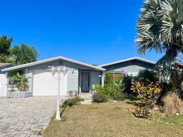 view of front of home with a front yard and a garage