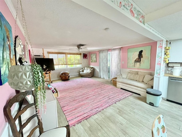 interior space featuring ceiling fan, a textured ceiling, and light hardwood / wood-style flooring