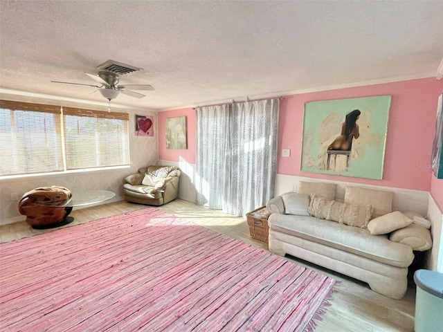 interior space featuring ceiling fan, light hardwood / wood-style floors, and a textured ceiling