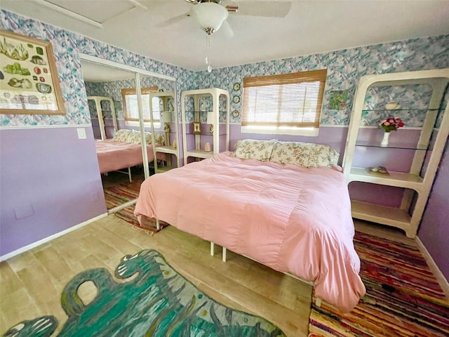 bedroom with ceiling fan and a closet