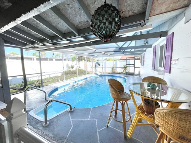 view of pool with a patio area and a lanai