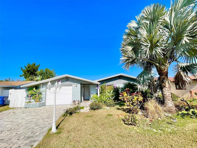 ranch-style home with a front lawn and a garage