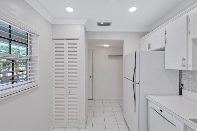 kitchen featuring white appliances, white cabinets, light tile patterned floors, ornamental molding, and tasteful backsplash