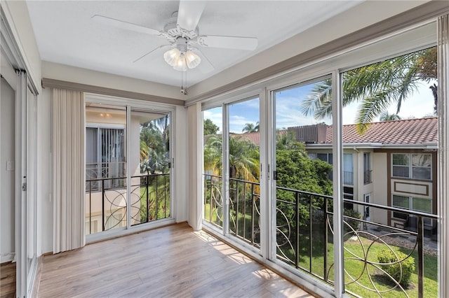 sunroom / solarium featuring ceiling fan