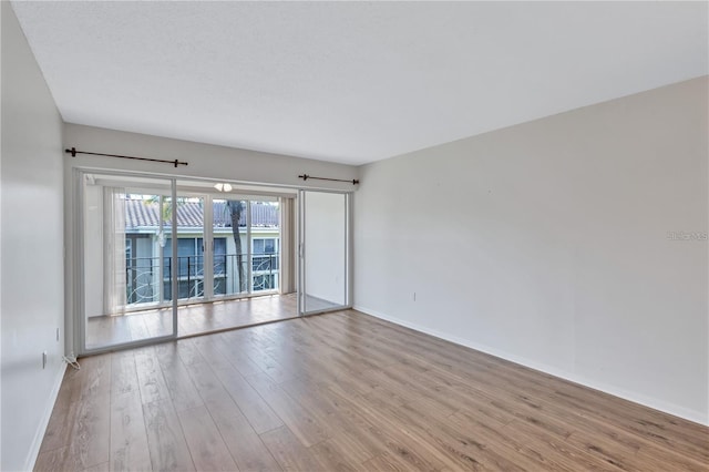 unfurnished room with light hardwood / wood-style flooring