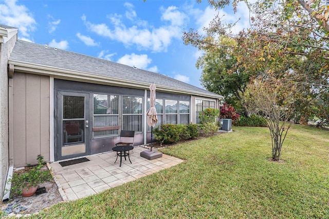 view of yard featuring central air condition unit and a patio