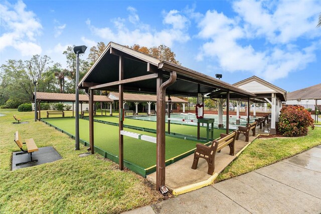 view of property's community with a lawn