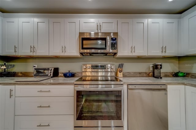 bar with white cabinets and appliances with stainless steel finishes