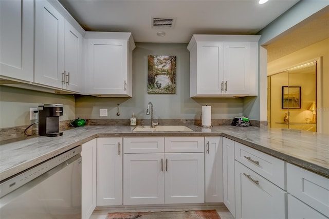 kitchen featuring dishwasher, light stone countertops, white cabinetry, and sink