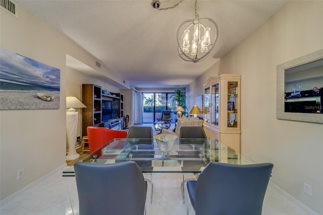 dining room with a textured ceiling, a notable chandelier, and light tile patterned flooring