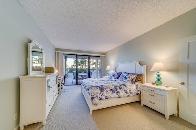 carpeted bedroom featuring access to outside and a textured ceiling