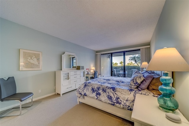 bedroom featuring carpet flooring, access to exterior, and a textured ceiling