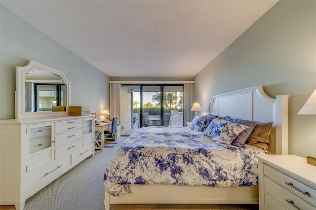 bedroom with a textured ceiling, access to outside, and light colored carpet