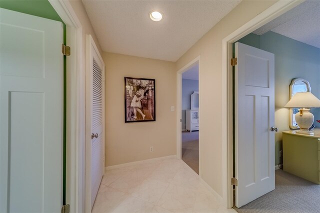 corridor featuring a textured ceiling