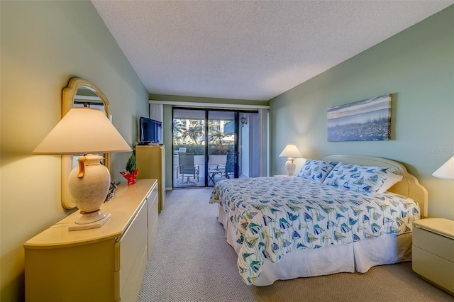 bedroom featuring a textured ceiling, access to outside, and light colored carpet