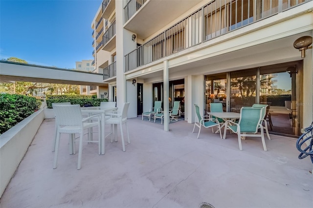 view of patio featuring a balcony