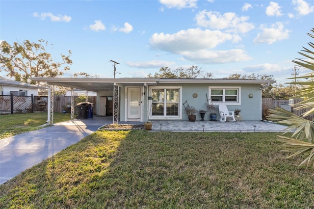 exterior space featuring a front lawn and a carport