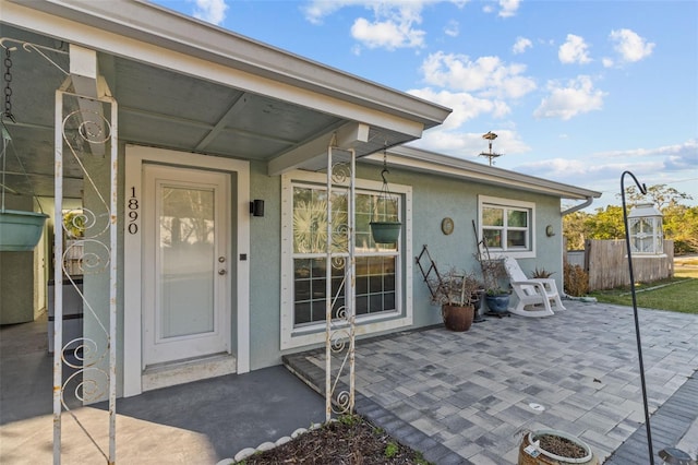 property entrance featuring a patio