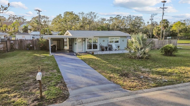 ranch-style home featuring a carport and a front yard