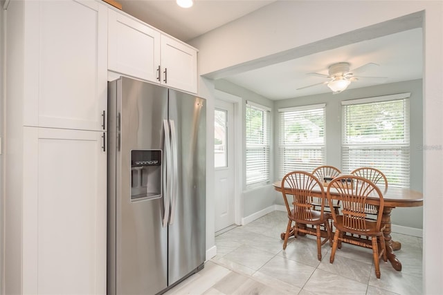 kitchen with stainless steel fridge with ice dispenser, white cabinets, a healthy amount of sunlight, and ceiling fan