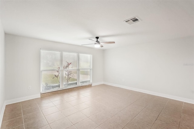 empty room featuring ceiling fan and light tile patterned flooring