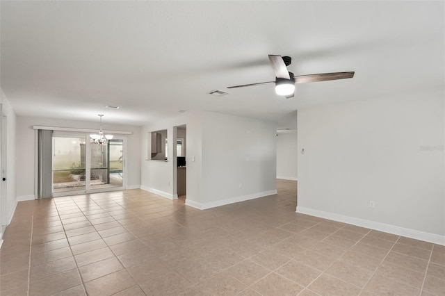 tiled empty room with ceiling fan with notable chandelier