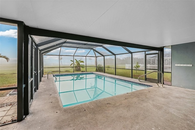 view of swimming pool featuring a lanai and a patio area