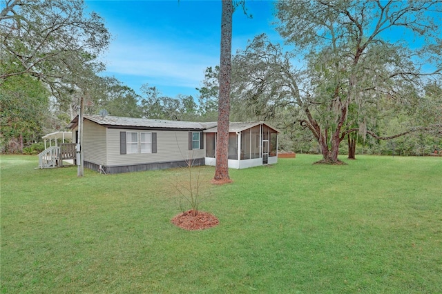 view of front facade featuring a sunroom and a front lawn