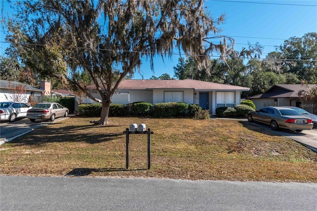 ranch-style house with a front lawn