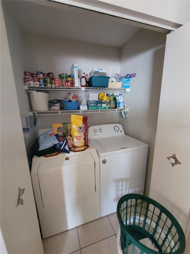 laundry area featuring light tile patterned flooring and separate washer and dryer